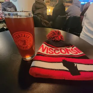 a beanie and a glass of beer
