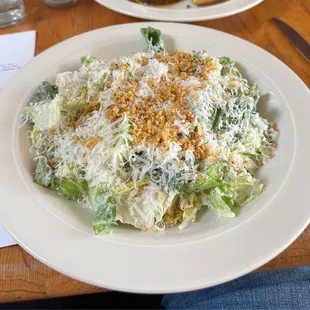 a plate of salad on a wooden table