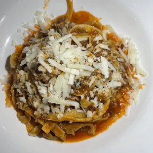 a plate of pasta with meat and cheese