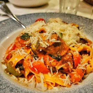 a plate of pasta with meat and vegetables