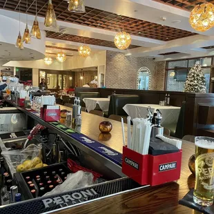 a restaurant with a bar and a glass of beer