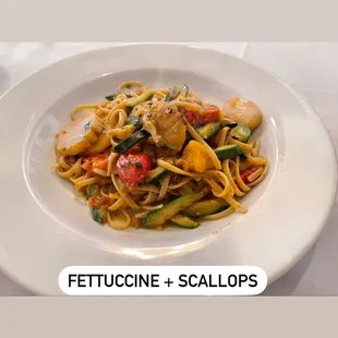 a plate of pasta with meat and vegetables