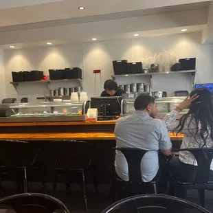 Guy behind the sushi bar goes crazy with the food