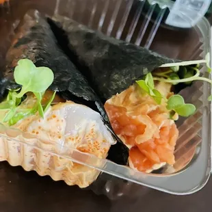 a close up of a plastic container with sushi