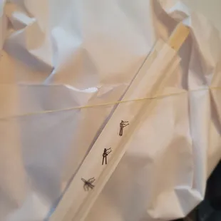 a close up of a piece of paper with a stick sticking out of it