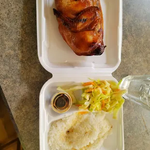 a chicken and rice dish in a styrofoam container