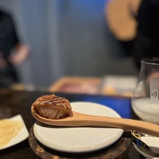 a wooden spoon with food on it