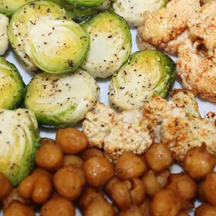 a plate of food with chicken, brussels sprouts, and chickpeas