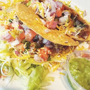 a plate of tacos and guacamole