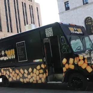 a food truck parked on the side of the street