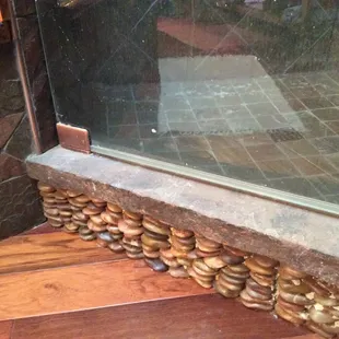 Natural slate shower curb with pebble detail.