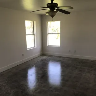 an empty room with a ceiling fan