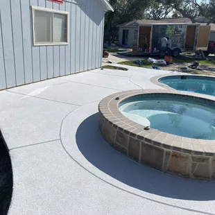 a concrete patio with a hot tub