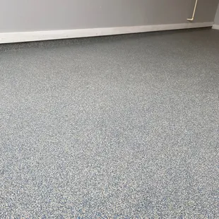 a room with blue and white speckled flooring