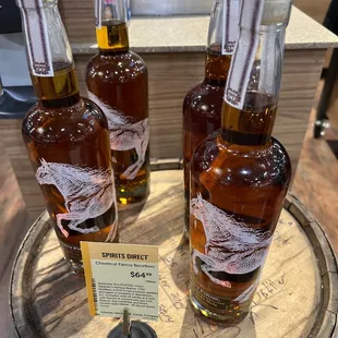 three bottles on a barrel