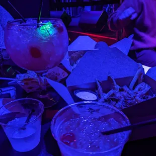 a woman sitting at a table with drinks