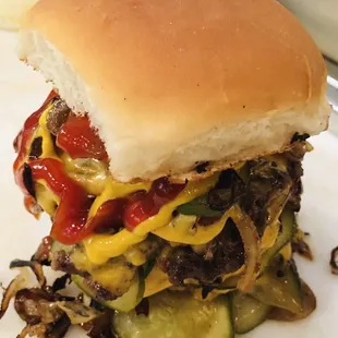 Close up of the Sir Arthur- a quadruple stacked Angus beef patty cheeseburger. Add another patty and get it named after you!