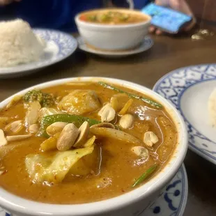 Massaman Curry with veggies pictures, front. Red curry with chicken, back.