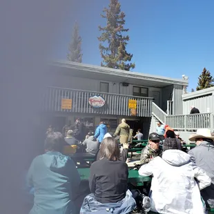 people sitting at picnic tables