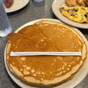 a stack of pancakes with a knife sticking out of it