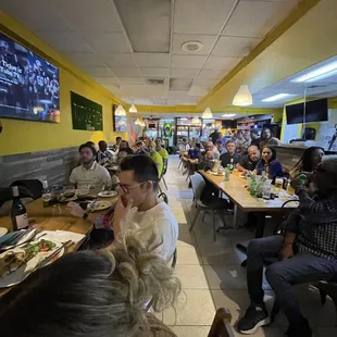 a large group of people eating at a restaurant