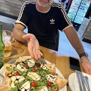 My husband Marcus displaying the most delicious Pizza! ITs called a star  pizza!