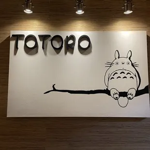 a totoro sitting on a branch