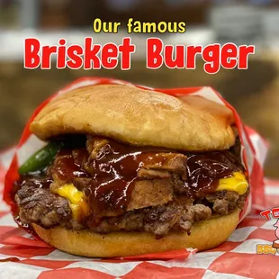 a beef burger with a red and white checkered tablecloth