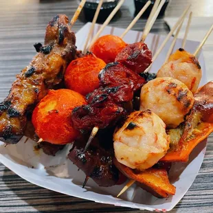a plate of skewered food
