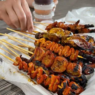 Mixed Filipino street food: chicken and pork isaw, pork barbecue, adidas, grilled liver etc.