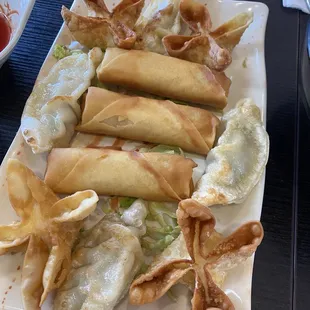 Sampler with potstickers, cheese puffs and egg rolls.