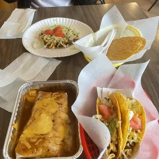 Sunken burrito with tostados, and two beef tacos. Chalupa with lettuce and tomatoes.