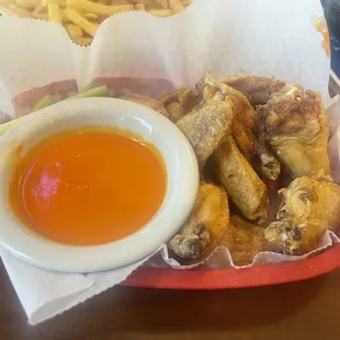 Lemon pepper wings with a side of buffalo sauce