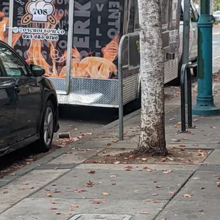 a black car parked on the side of the street