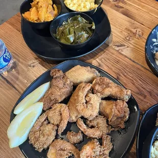 Combo plate of fried chicken and prawns with greens, mac n cheese and yams. Smothered porkchops!