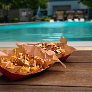 two baskets of food near a pool