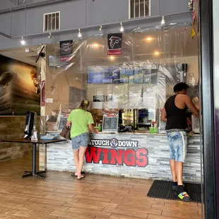 two people standing in front of a counter