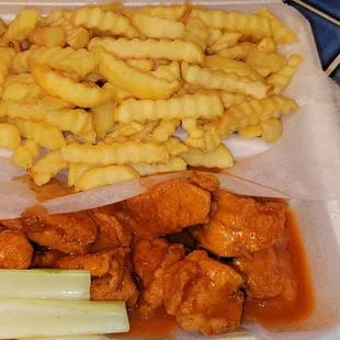 a container of chicken and french fries