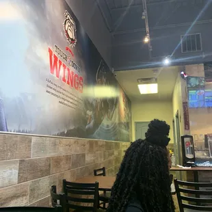 a woman sitting at a table in a restaurant