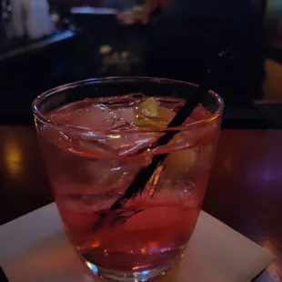 a drink in a glass on a napkin