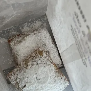 two pieces of powdered sugar pastries