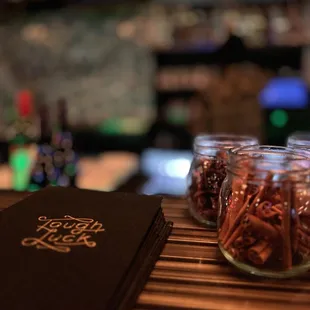 a book and a jar of nuts on a table