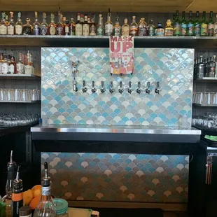 a bar with a lot of bottles on the shelves