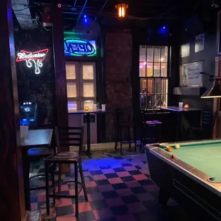 a pool table and neon signs