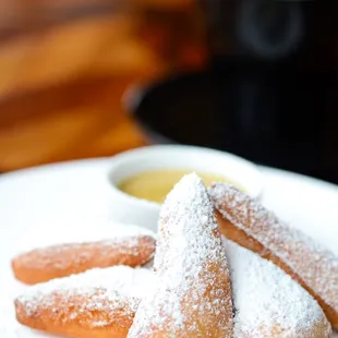 Seattle&apos;s Best Beignets with powdered sugar and chicory café anglaise