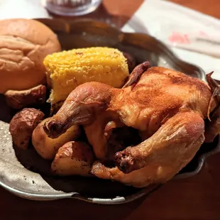 Cornish hen, potatoes, corn, bread. Not very good and no utensils so you&apos;ll get messy.