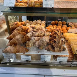 a variety of pastries in a display case