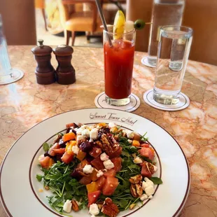 a plate of salad and a drink