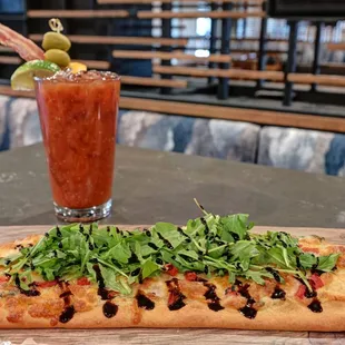 a pizza and a bloody drink