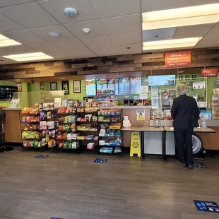 a man standing in front of a vending machine